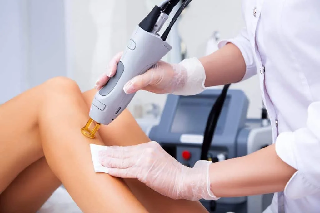What to Expect During a Laser Hair Removal Treatment: A Step-by-Step Guide 1 Laser hair removal technician treating client’s leg